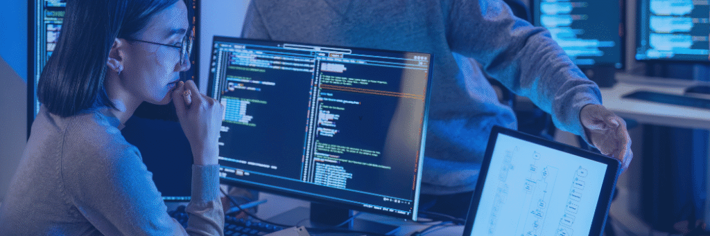 **Alt Text:** Kanerika blog banner for liquid clustering in Databricks showing developers reviewing code and data workflows on multiple screens.