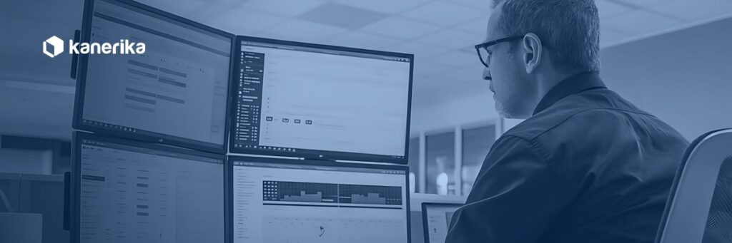 Engineer reviewing data across multiple monitors, representing data migration testing