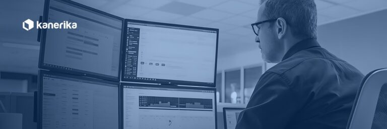 Engineer reviewing data across multiple monitors, representing data migration testing