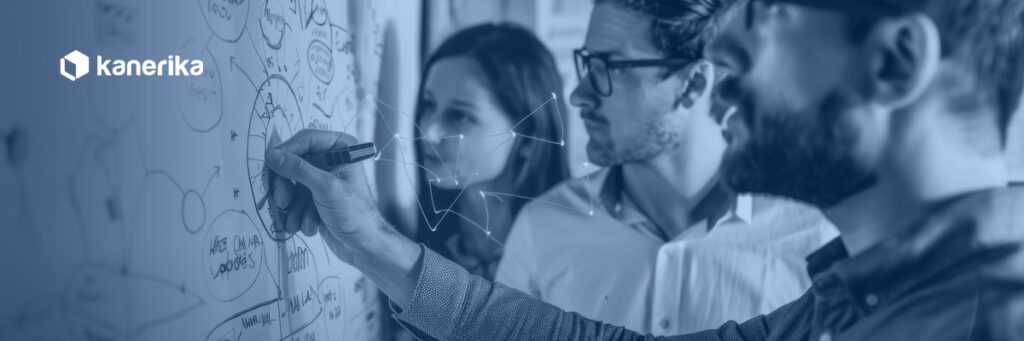 Engineering team mapping architecture on a whiteboard, representing Databricks Workflows orchestration