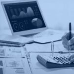 Finance analyst calculating budget with a BI dashboard and reports, representing Snowflake cost optimization and cloud spend management