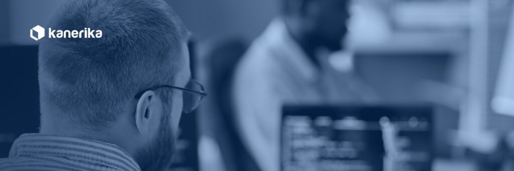 Developer writing database code at a workstation, representing Snowflake stored procedures and SQL scripting