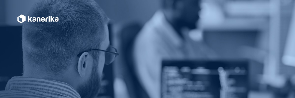Developer writing database code at a workstation, representing Snowflake stored procedures and SQL scripting