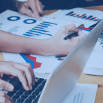 Kanerika blog banner for enterprise data migration showing teams reviewing charts, reports, and business data.