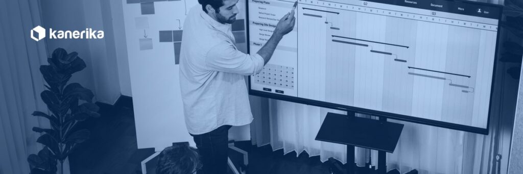 Agile vs Waterfall software delivery team reviewing a Waterfall Gantt chart and Agile sprint planning board on screen