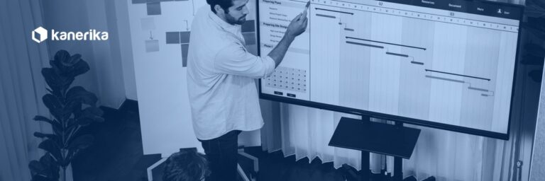Agile vs Waterfall software delivery team reviewing a Waterfall Gantt chart and Agile sprint planning board on screen