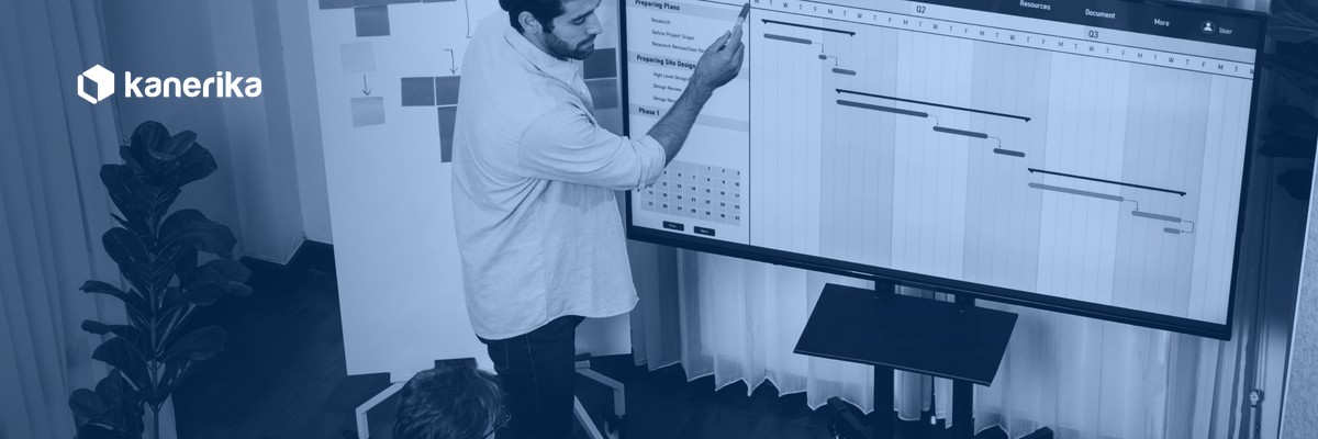 Agile vs Waterfall software delivery team reviewing a Waterfall Gantt chart and Agile sprint planning board on screen