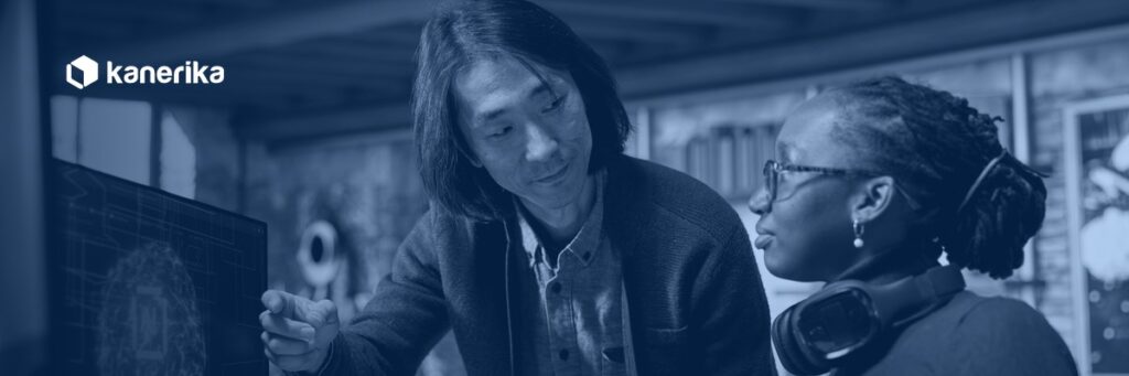 Kanerika AI engineer and colleague reviewing an AI proof of concept model on screen