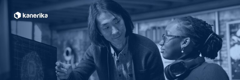 Kanerika AI engineer and colleague reviewing an AI proof of concept model on screen