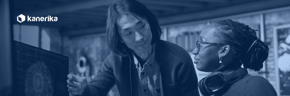 Kanerika AI engineer and colleague reviewing an AI proof of concept model on screen