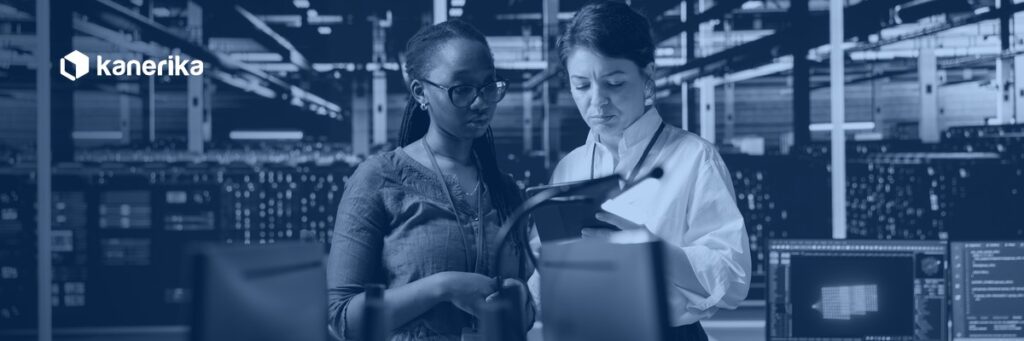 Two engineers reviewing cloud infrastructure in a data center, planning an enterprise AWS to Azure migration