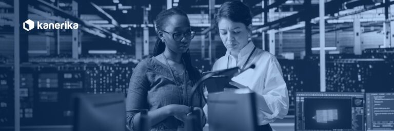 Two engineers reviewing cloud infrastructure in a data center, planning an enterprise AWS to Azure migration