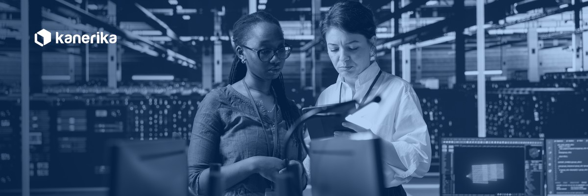 Two engineers reviewing cloud infrastructure in a data center, planning an enterprise AWS to Azure migration