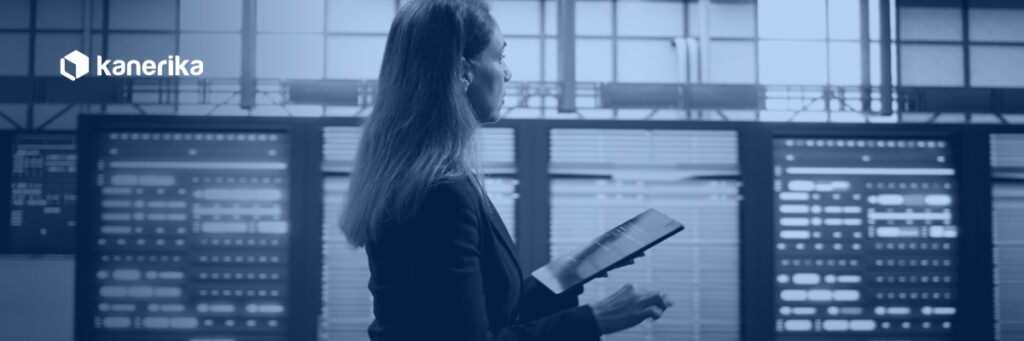 Data platform engineer reviewing server racks on a tablet, representing Databricks metastore governance across a cloud region