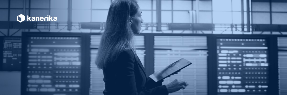 Data platform engineer reviewing server racks on a tablet, representing Databricks metastore governance across a cloud region