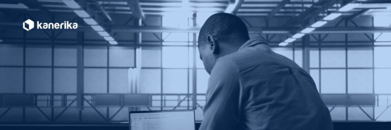 Data engineer reviewing ETL process optimization code on a laptop in a data center, Kanerika navy duotone hero banner