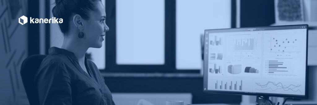 Kanerika data analyst hiring guide banner — analyst reviewing Power BI dashboards, hire data analyst
