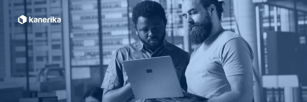 Kanerika banner for software development companies evaluation guide, engineers reviewing code together