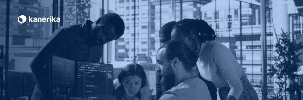 Kanerika banner showing a software engineering team collaborating around a monitor in an office, illustrating employee versus contractor staffing decisions