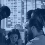 Kanerika banner showing a software engineering team collaborating around a monitor in an office, illustrating employee versus contractor staffing decisions