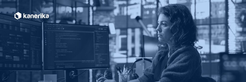 Software engineer working on agentic AI web development, an autonomous coding agent assisting with a web application build on a dual-monitor setup