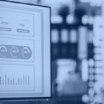 Kanerika AI data quality: business analyst reviewing analytics dashboards on screen