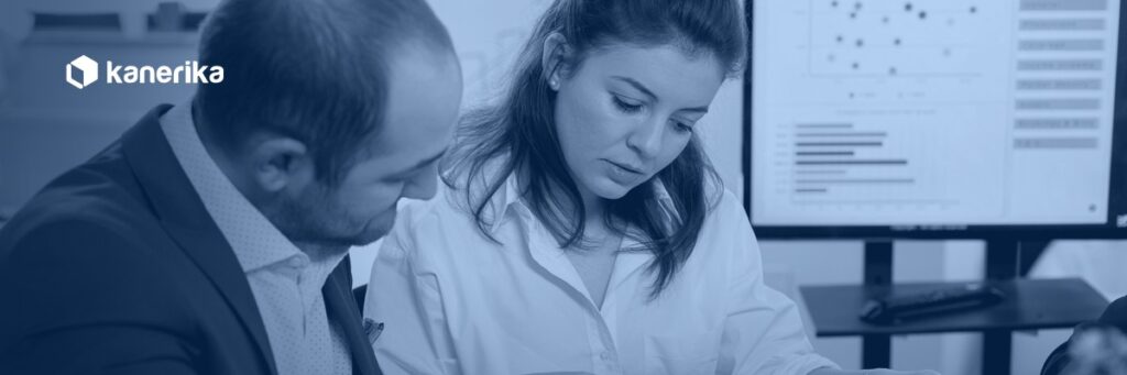 Two compliance professionals reviewing reports and a risk dashboard, illustrating AI governance risk and compliance oversight in an enterprise