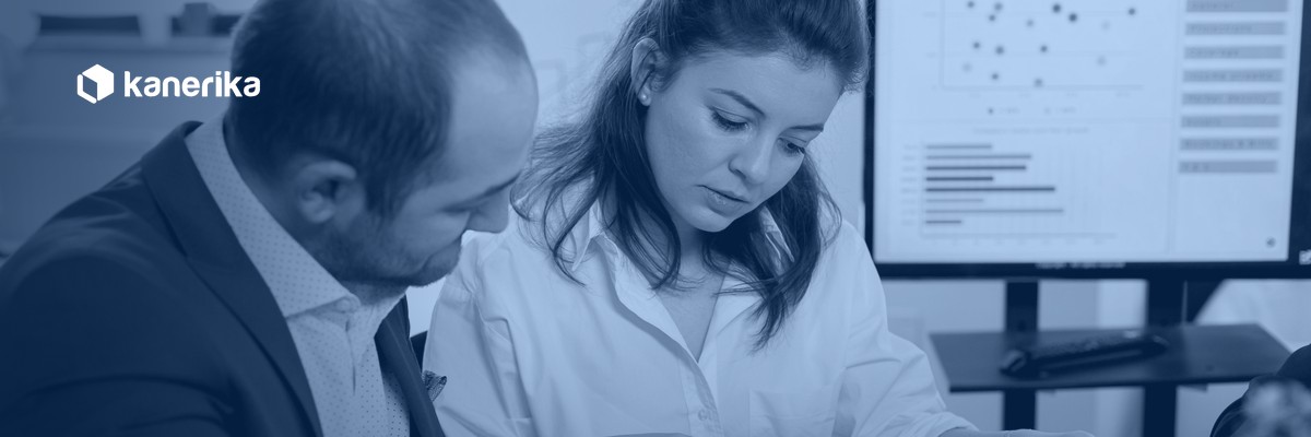 Two compliance professionals reviewing reports and a risk dashboard, illustrating AI governance risk and compliance oversight in an enterprise