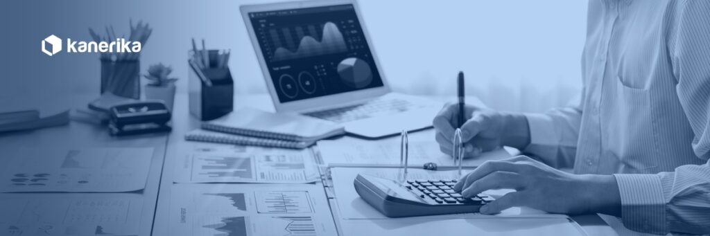 Analyst reviewing budget and BI dashboards while calculating Databricks cost optimization spend, Kanerika