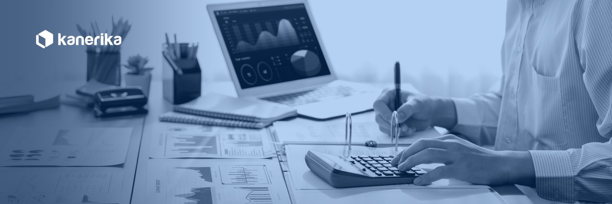 Analyst reviewing budget and BI dashboards while calculating Databricks cost optimization spend, Kanerika
