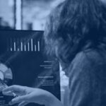 Data analyst reviewing a BI dashboard, hero banner for the Kanerika Databricks SQL warehouse guide