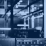 Data engineer reviewing Databricks system tables dashboards for cost, reliability, and governance monitoring in a data center