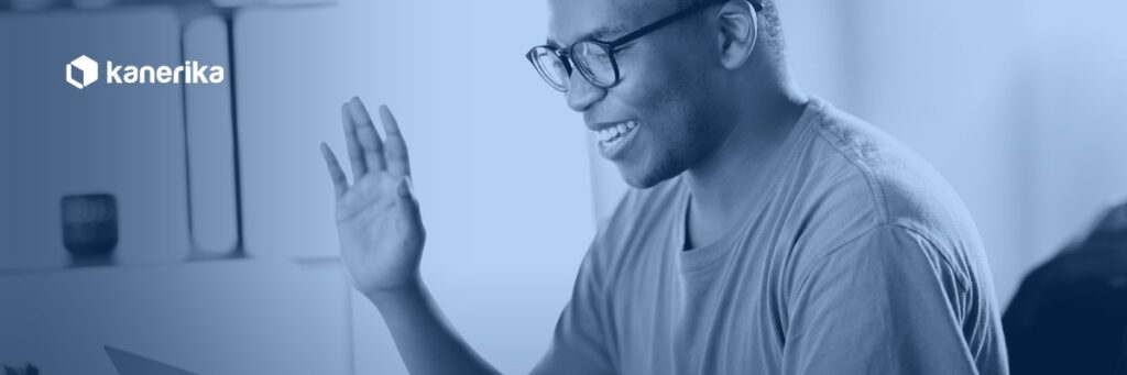 Remote software developer waving hello during a video call, representing how to hire remote developers for a distributed engineering team