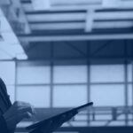 Data center engineer monitoring infrastructure, representing Snowflake temporary table session management, Kanerika blog banner