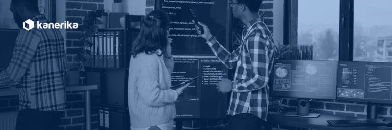 Software engineering team reviewing code together in a navy-toned Kanerika banner for software development toolkit