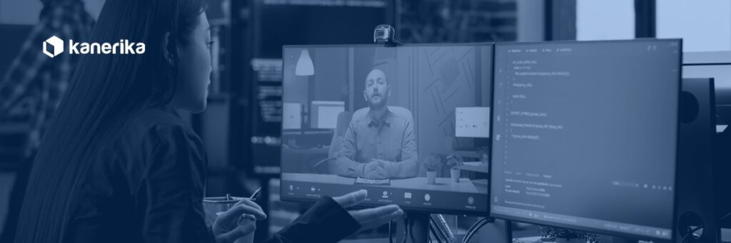 Software developer on a video call with a remote colleague, representing communication and integration in staff augmentation engagements, Kanerika