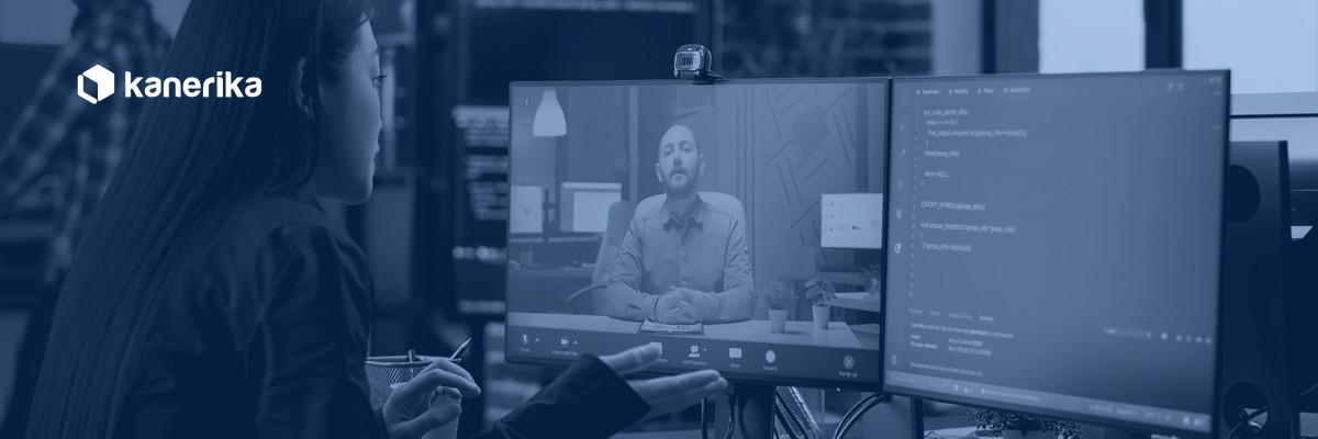 Software developer on a video call with a remote colleague, representing communication and integration in staff augmentation engagements, Kanerika