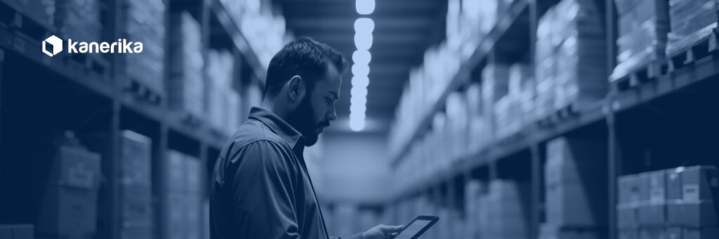 Warehouse manager reviewing supply chain data on a tablet, representing supply chain master data management