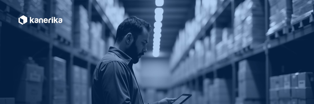 Warehouse manager reviewing supply chain data on a tablet, representing supply chain master data management