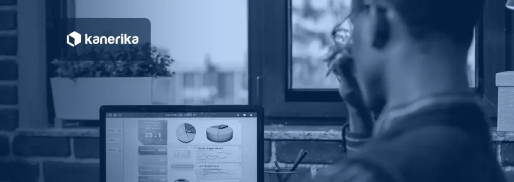 Business analyst reviewing an AI-powered business analytics dashboard on a laptop