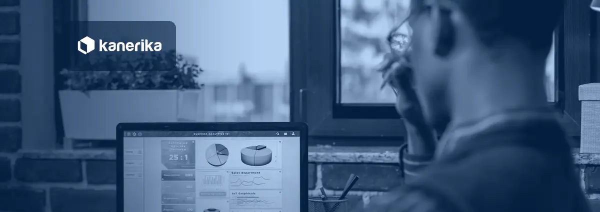 Business analyst reviewing an AI-powered business analytics dashboard on a laptop