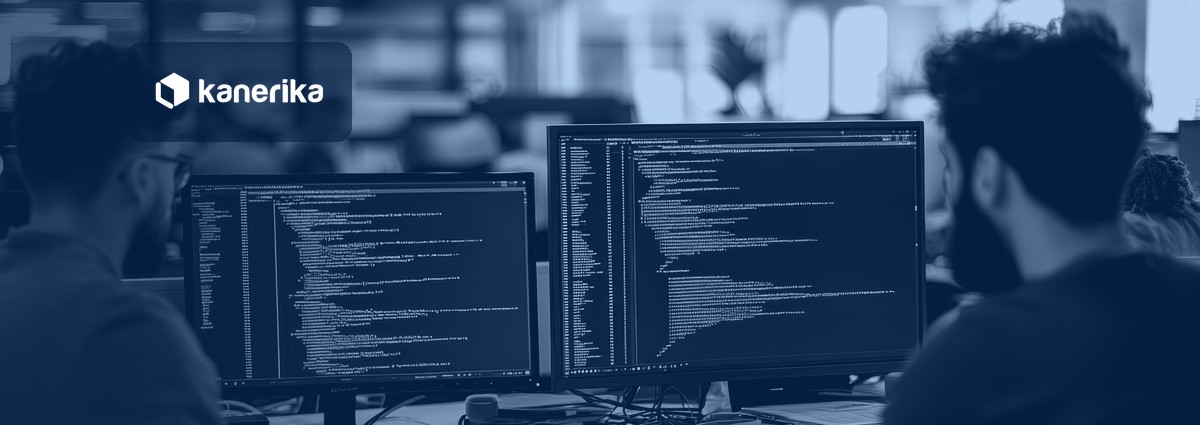 Developers reviewing agent code on dual monitors, illustrating AI agent frameworks evaluated in 2026