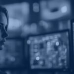Security analyst monitoring AI-driven identity and access management dashboards in a SOC