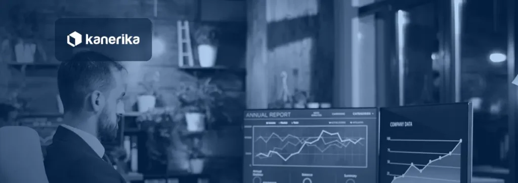 Analyst reviewing report charts on two monitors, illustrating custom data labels in Power BI report design