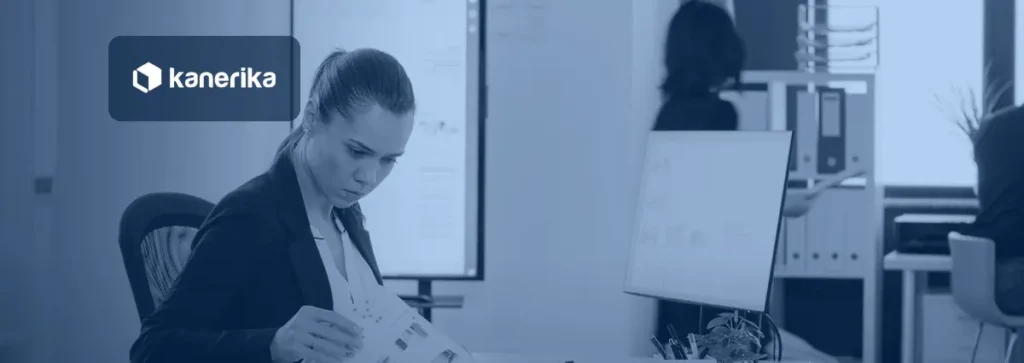 Business analyst reviewing a data governance and data management report, Kanerika