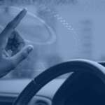 Edge computing in autonomous vehicles banner showing an in-vehicle heads-up display with sensor overlays