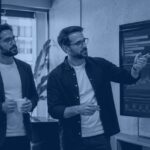 Engineering team reviewing a software delivery analytics dashboard showing engineering productivity metrics and deployment pipeline data