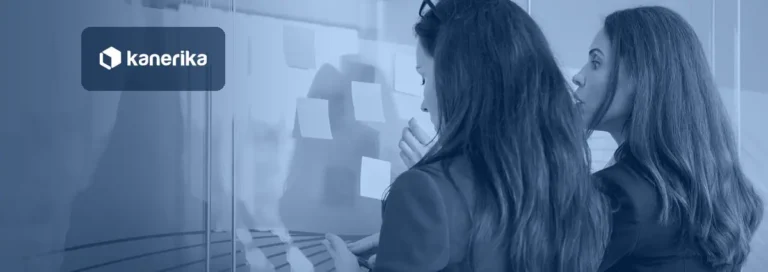 Business team mapping enterprise AI use cases with sticky notes on a glass wall, Kanerika blog banner