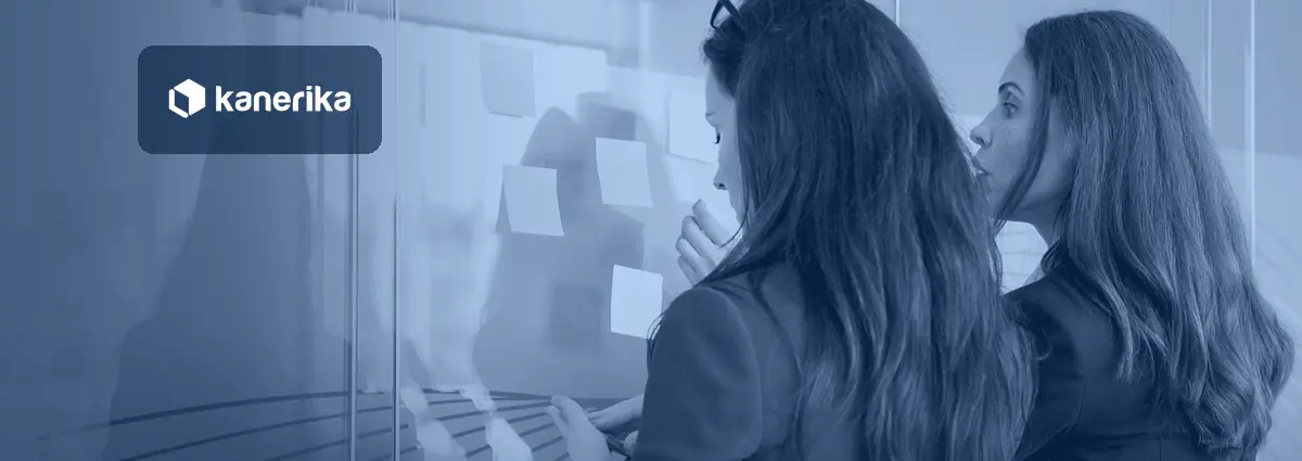 Business team mapping enterprise AI use cases with sticky notes on a glass wall, Kanerika blog banner