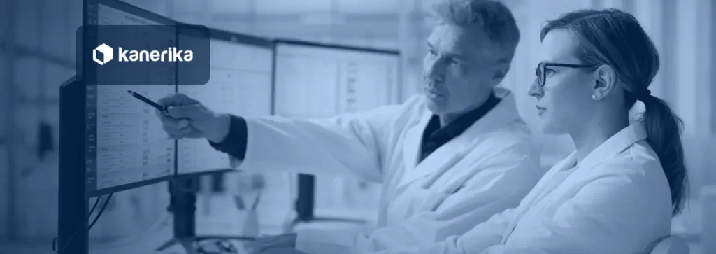 Two healthcare data analysts reviewing clinical and billing data on multiple monitors, illustrating healthcare staff augmentation for IT and data teams